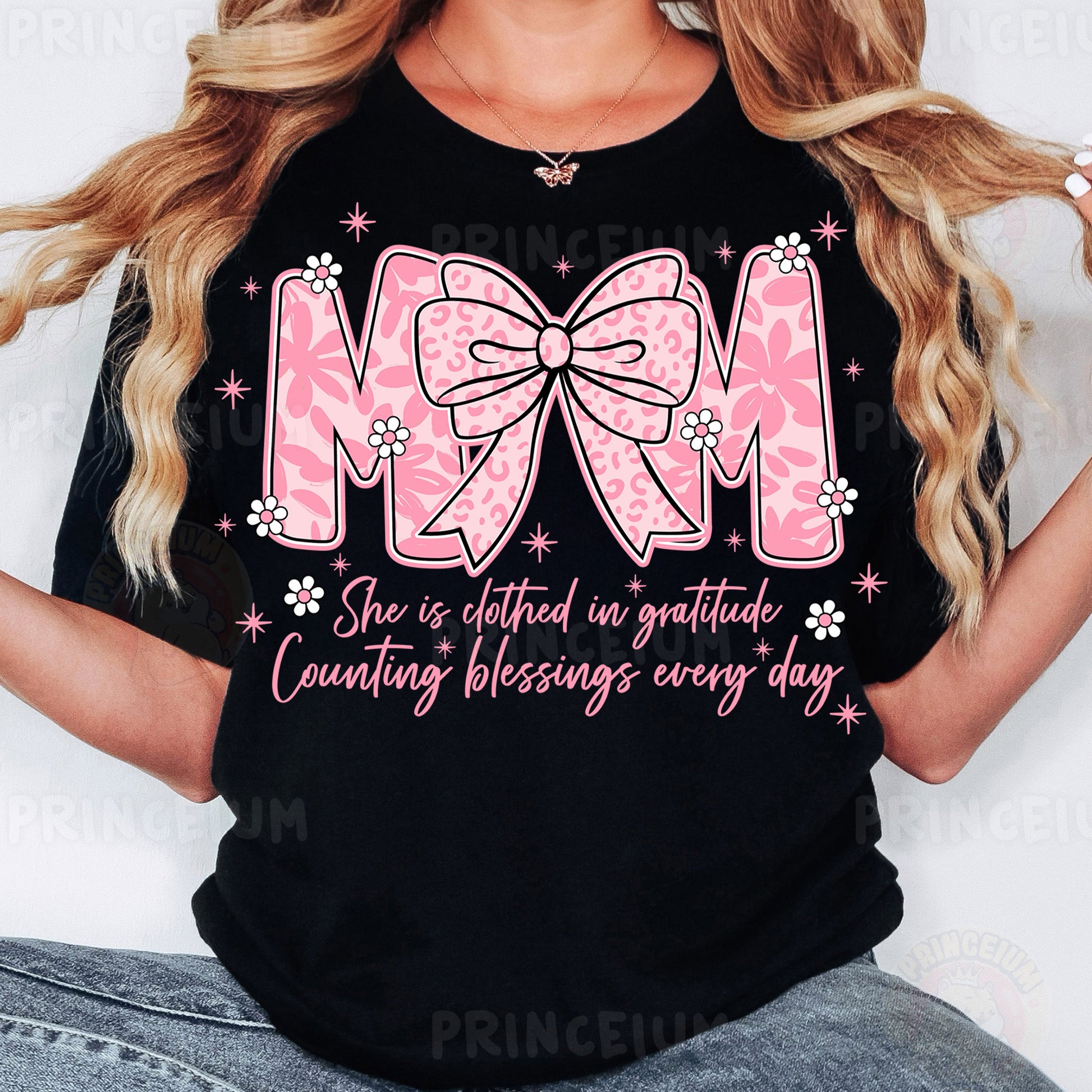 a woman wearing a black shirt with a pink bow