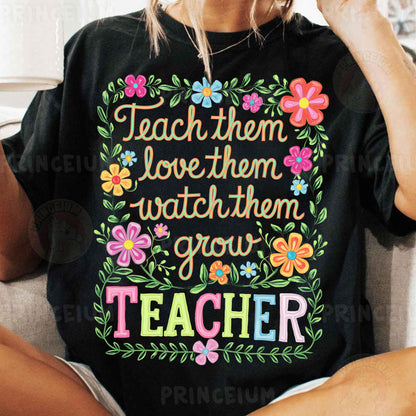 a woman sitting on a couch wearing a teacher shirt