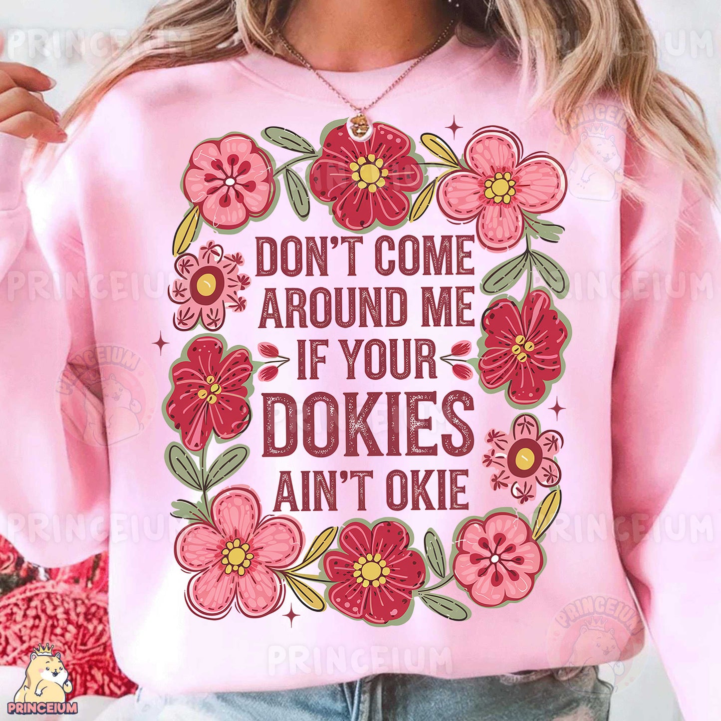 a woman wearing a pink sweatshirt with flowers on it