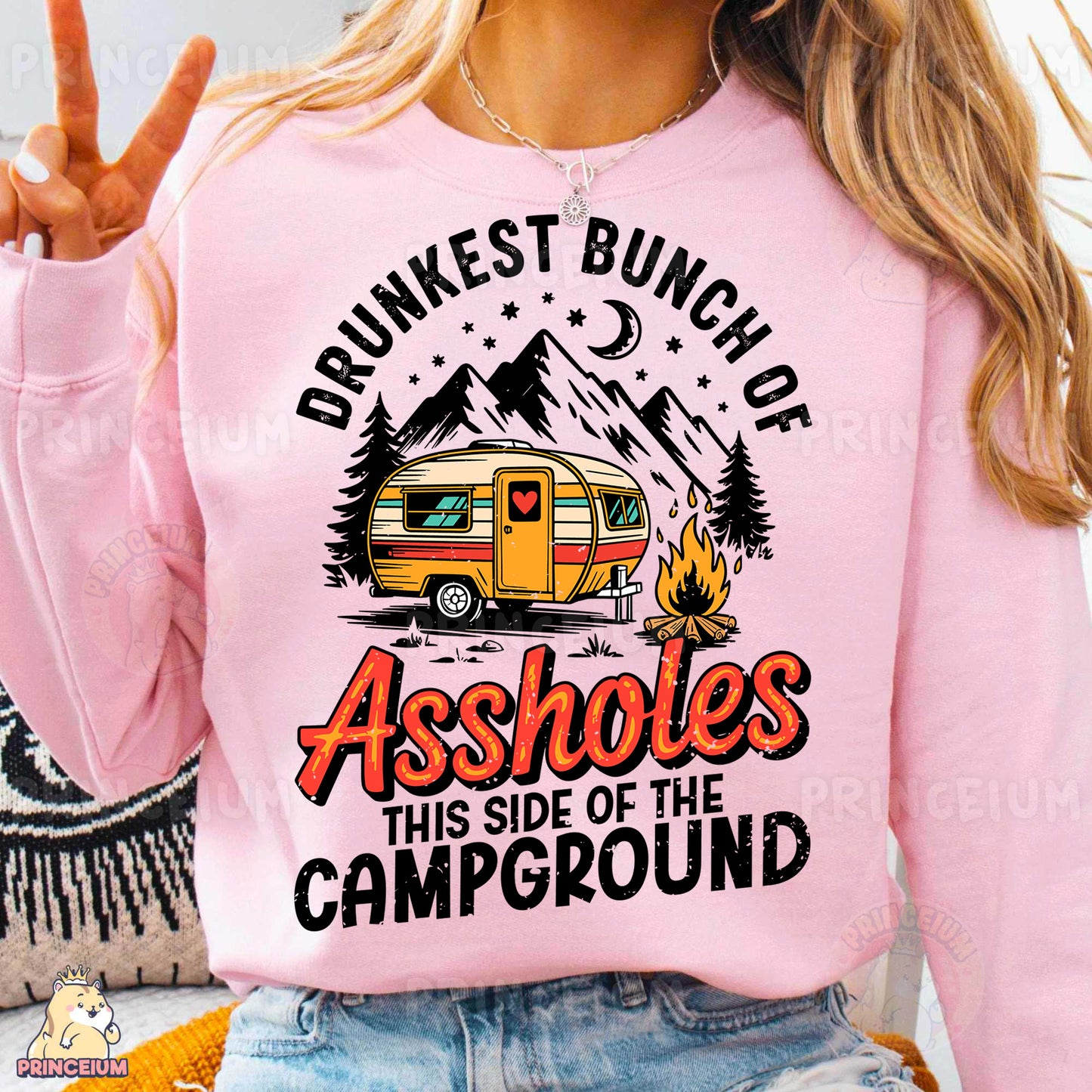 a woman wearing a pink sweatshirt with a camper on it