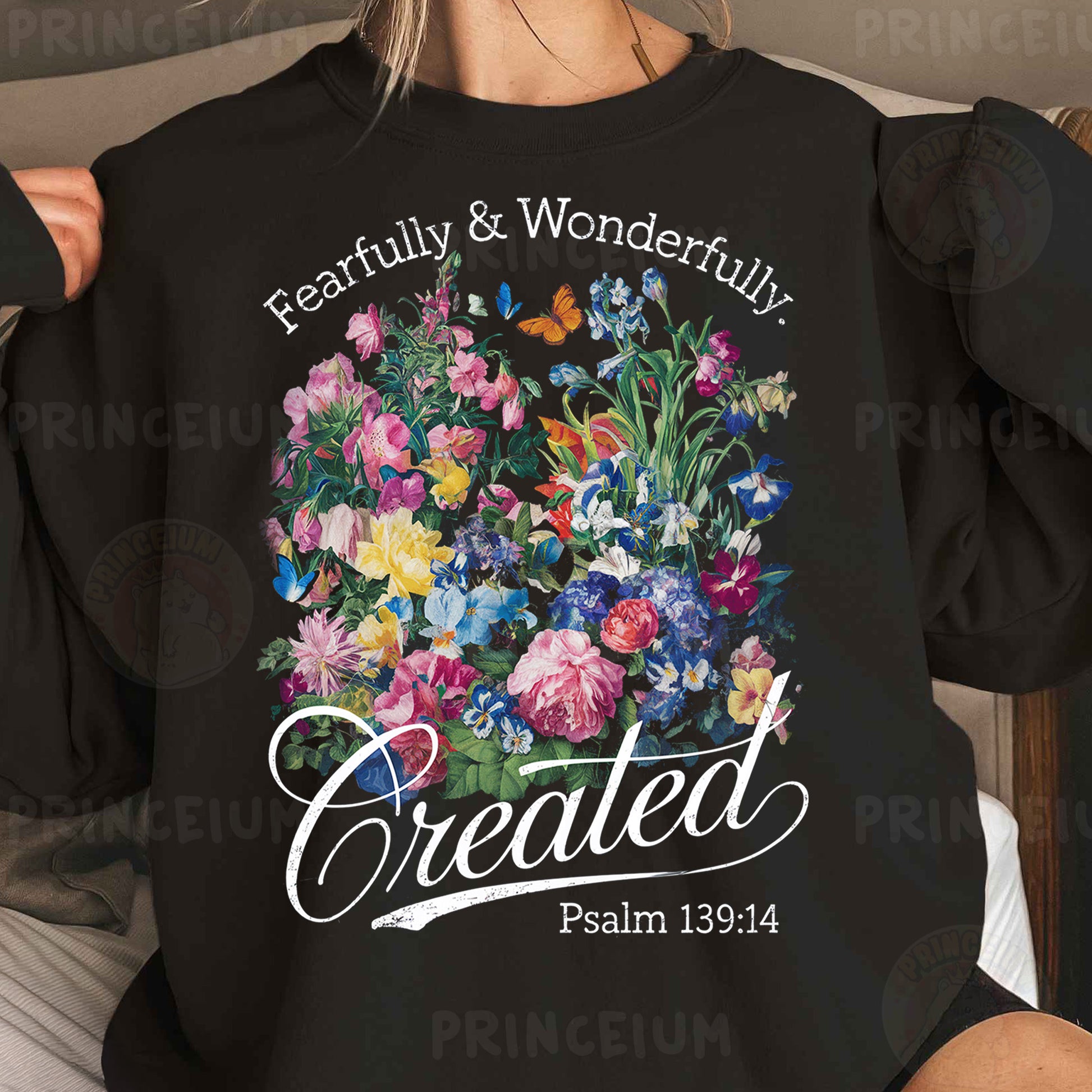 a woman wearing a black sweatshirt with flowers on it