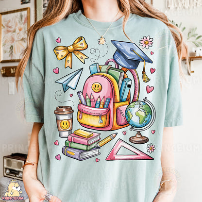 a woman wearing a t - shirt with a picture of a backpack and books