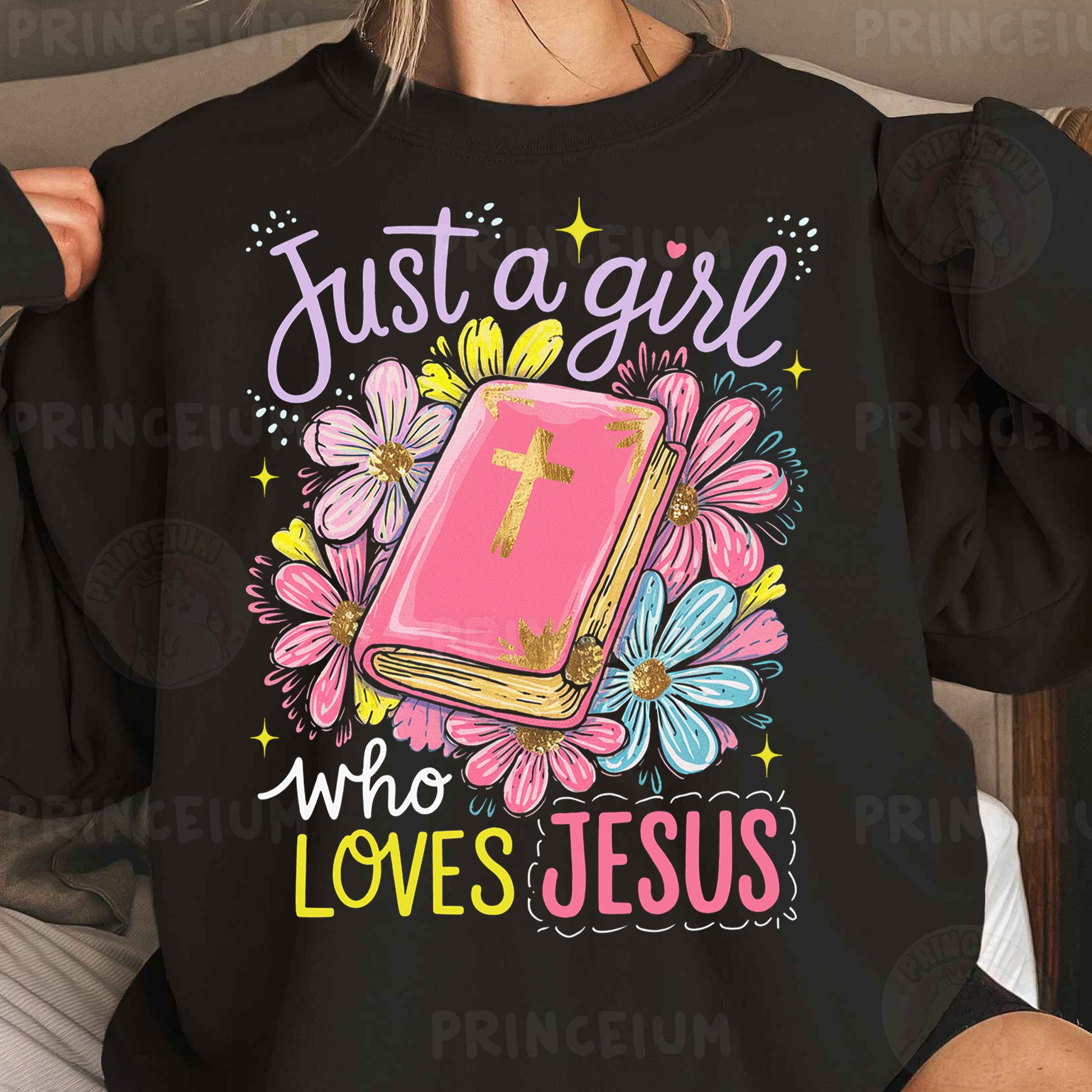 a woman wearing a black shirt that says just a girl who loves jesus