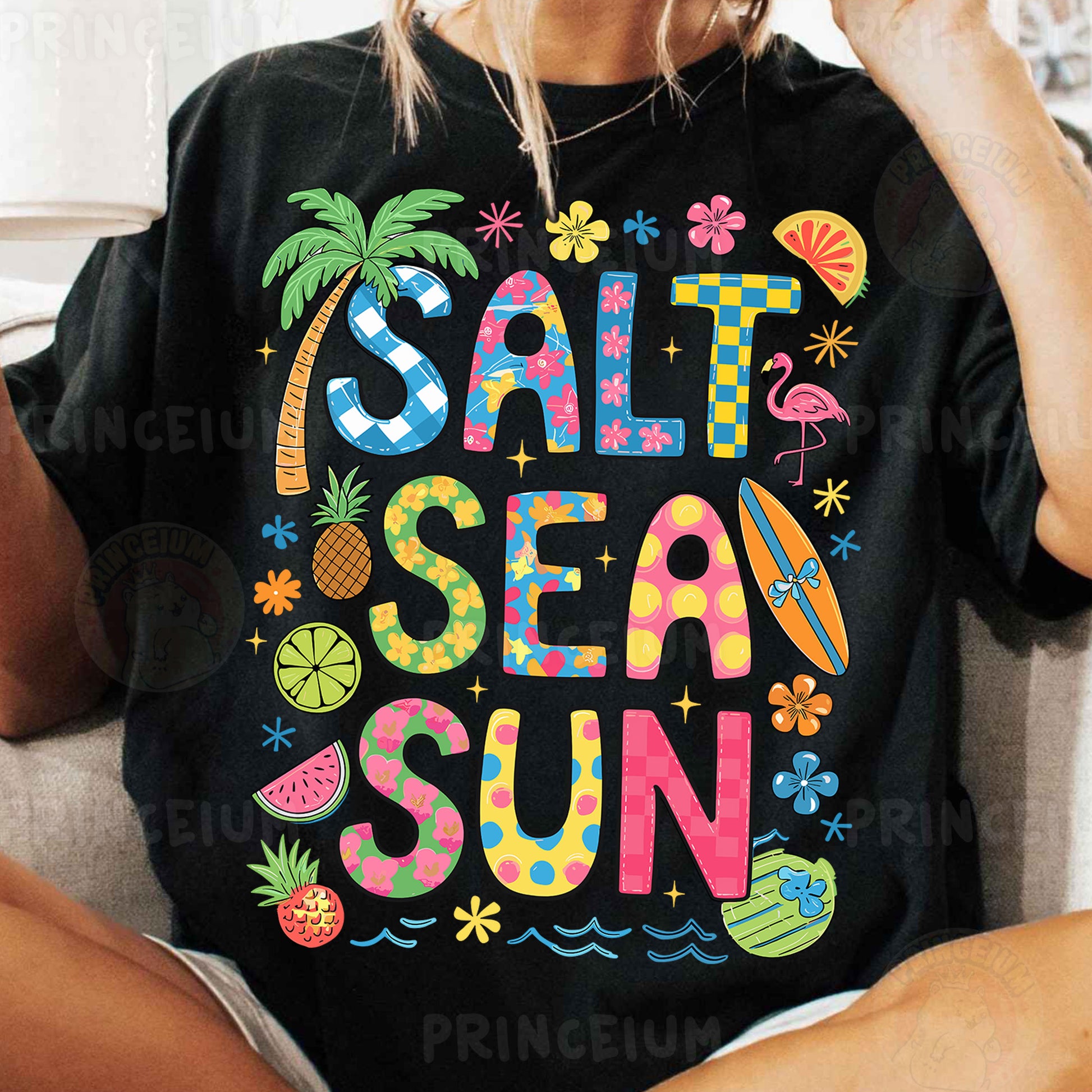 a woman sitting on a couch wearing a t - shirt that says salt sea sun