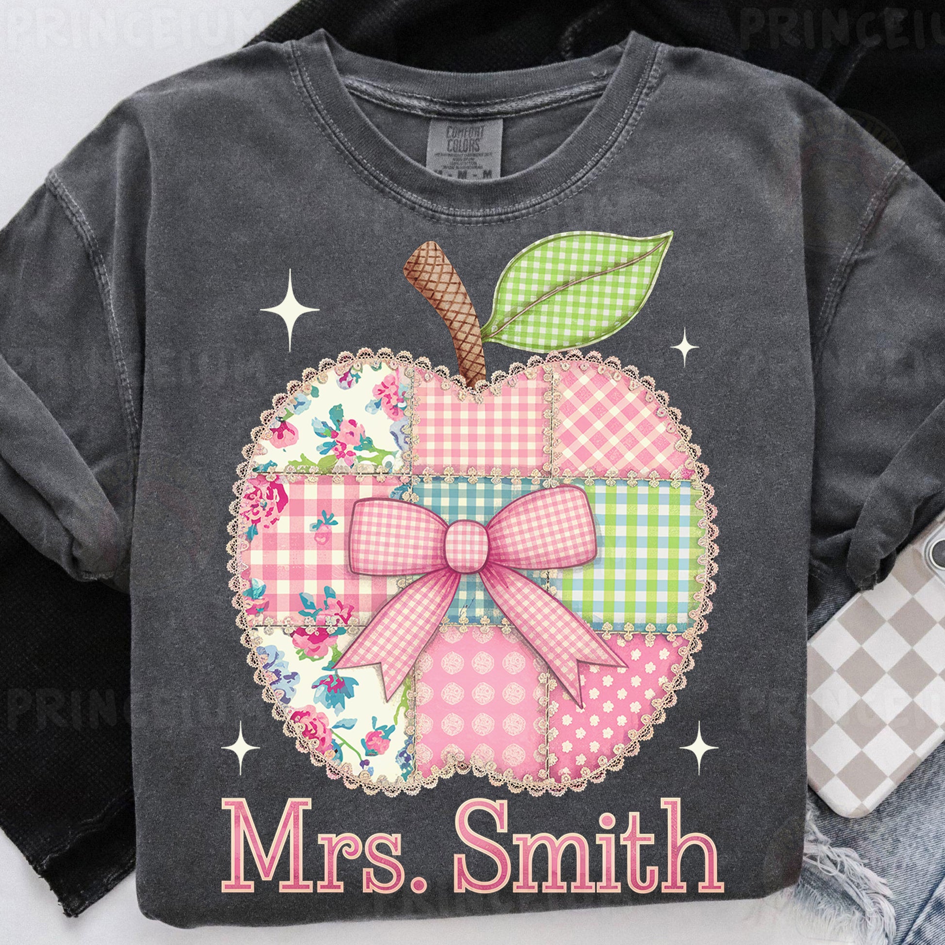 a gray shirt with a pink and green apple on it