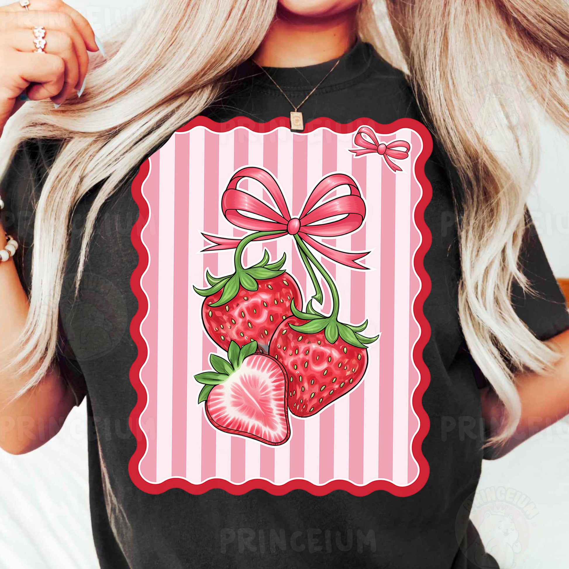 a woman wearing a black shirt with a pink bow and two strawberries on it