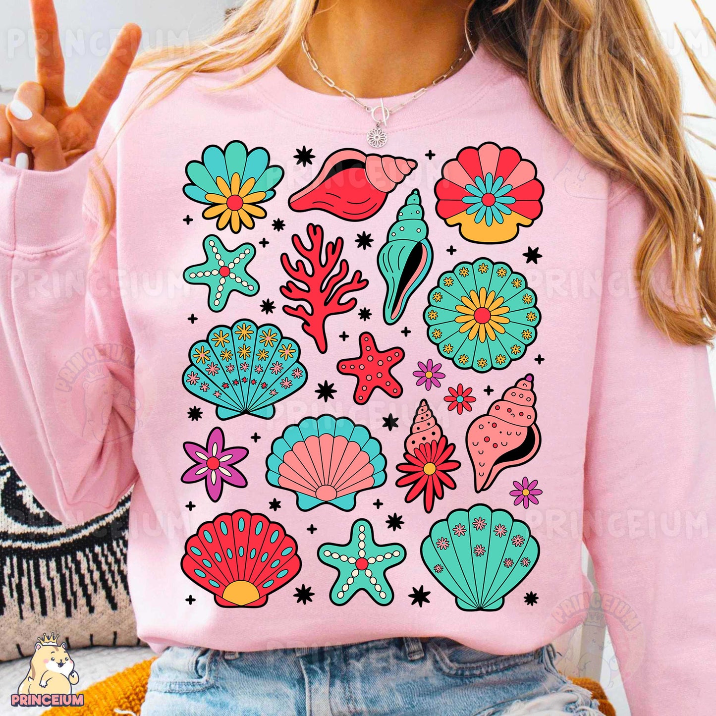 a woman wearing a pink sweater with colorful seashells on it