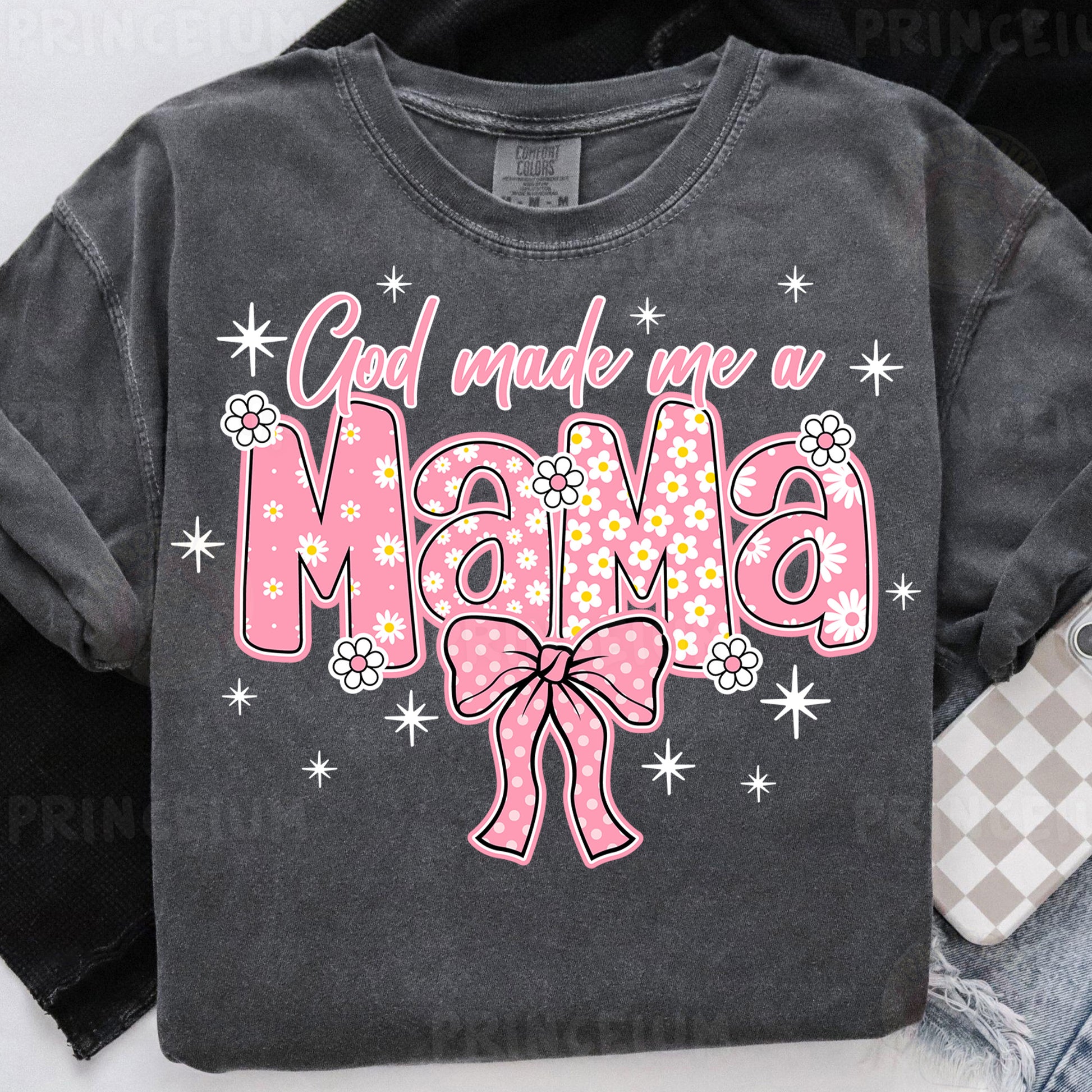 a black shirt with a pink bow on it