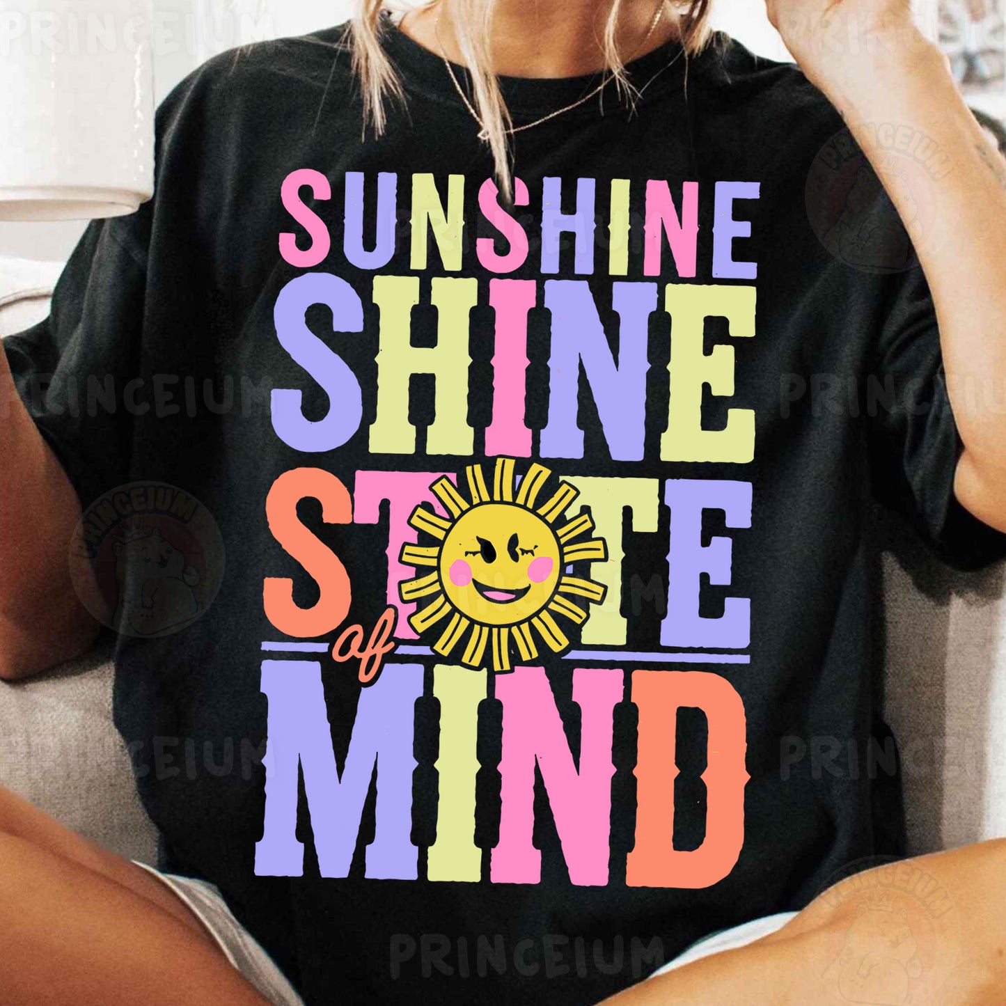 a woman sitting on a couch wearing a black shirt