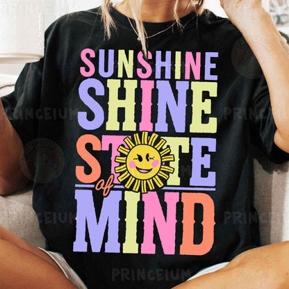 a woman sitting on a couch wearing a black shirt