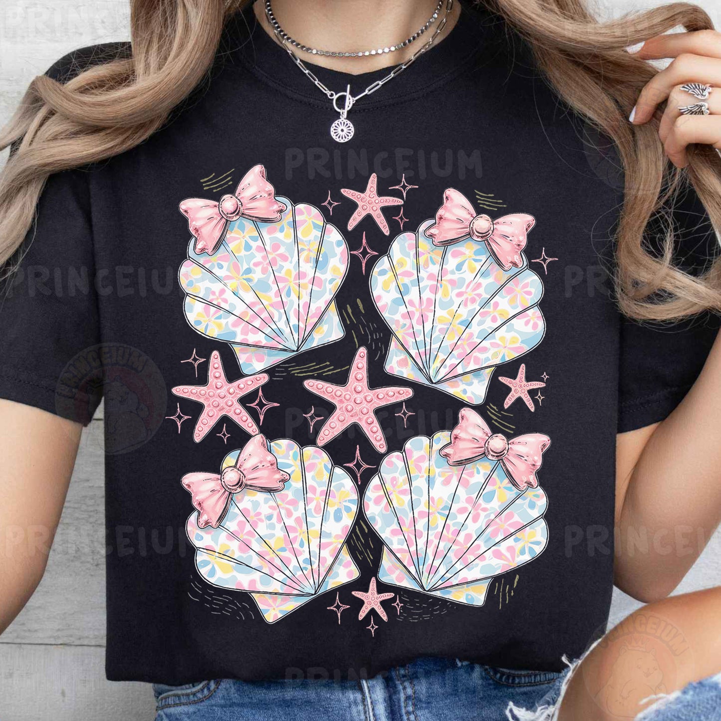 a woman wearing a t - shirt with seashells on it