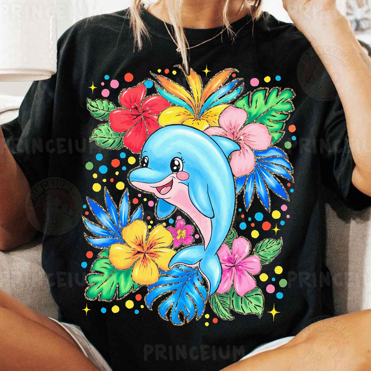 a woman sitting on a couch wearing a black shirt with a dolphin on it
