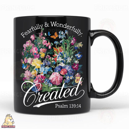a black coffee mug with a picture of flowers on it