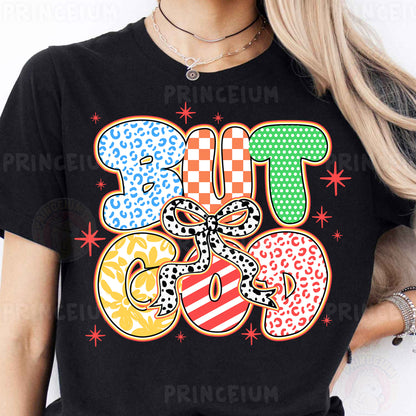 a woman wearing a black tshirt with colorful donuts on it