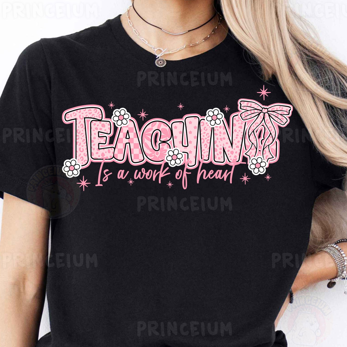 a woman wearing a black tshirt that says teaching is a work of heart