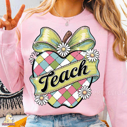 a woman wearing a pink sweater with a peace sign on it
