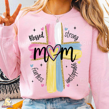 a woman wearing a pink shirt with a cross on it