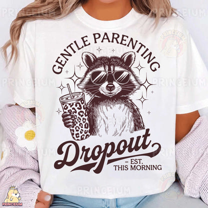 a woman wearing a white shirt with a raccoon holding a drink
