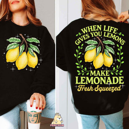 a woman wearing a black sweatshirt with lemons on it