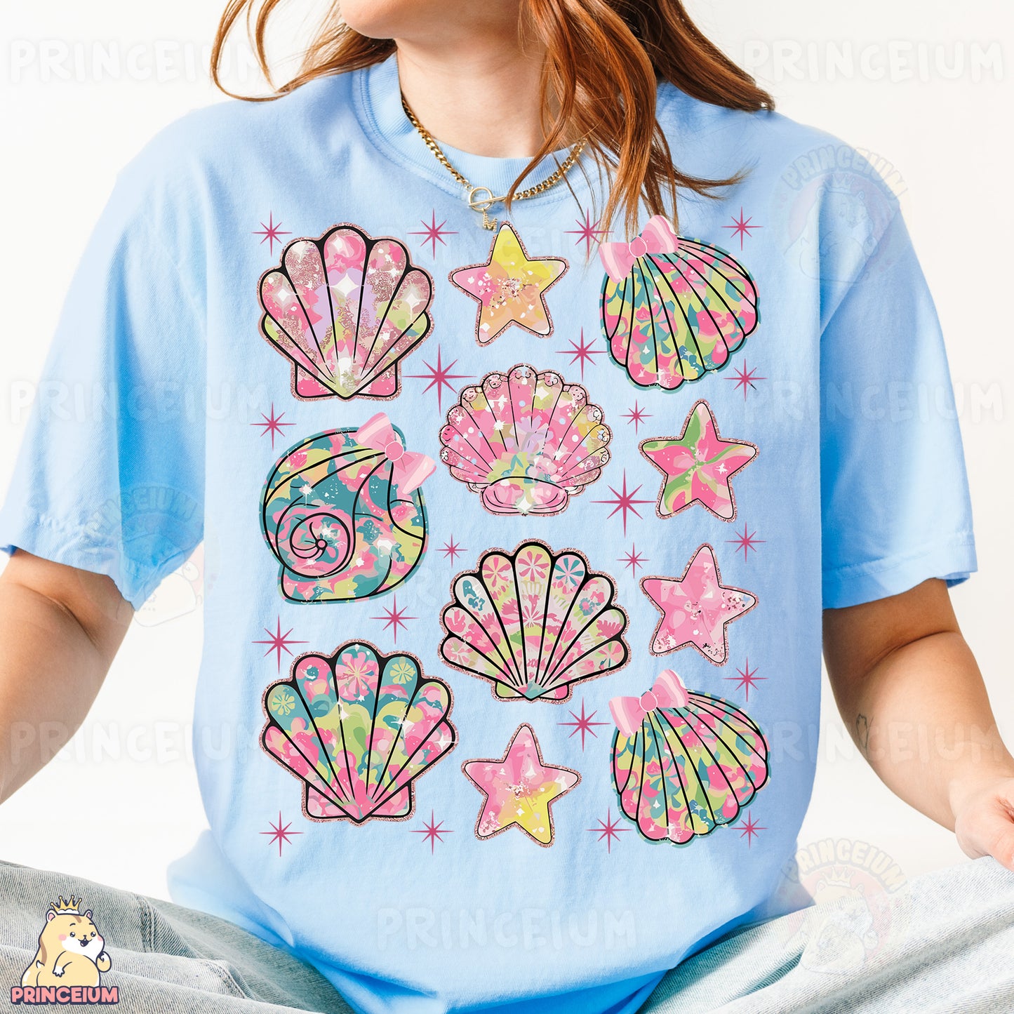 a young girl wearing a blue shirt with colorful seashells on it