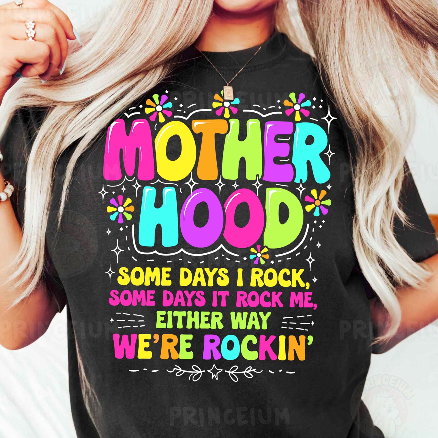 a woman wearing a black t - shirt that says motherhood some days i rock