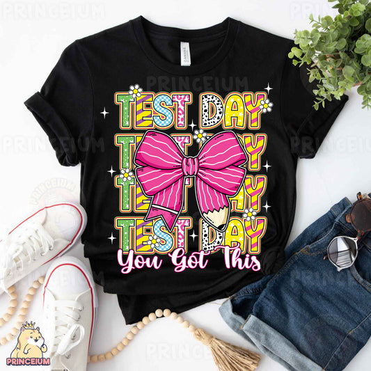 a black shirt with a pink bow on it