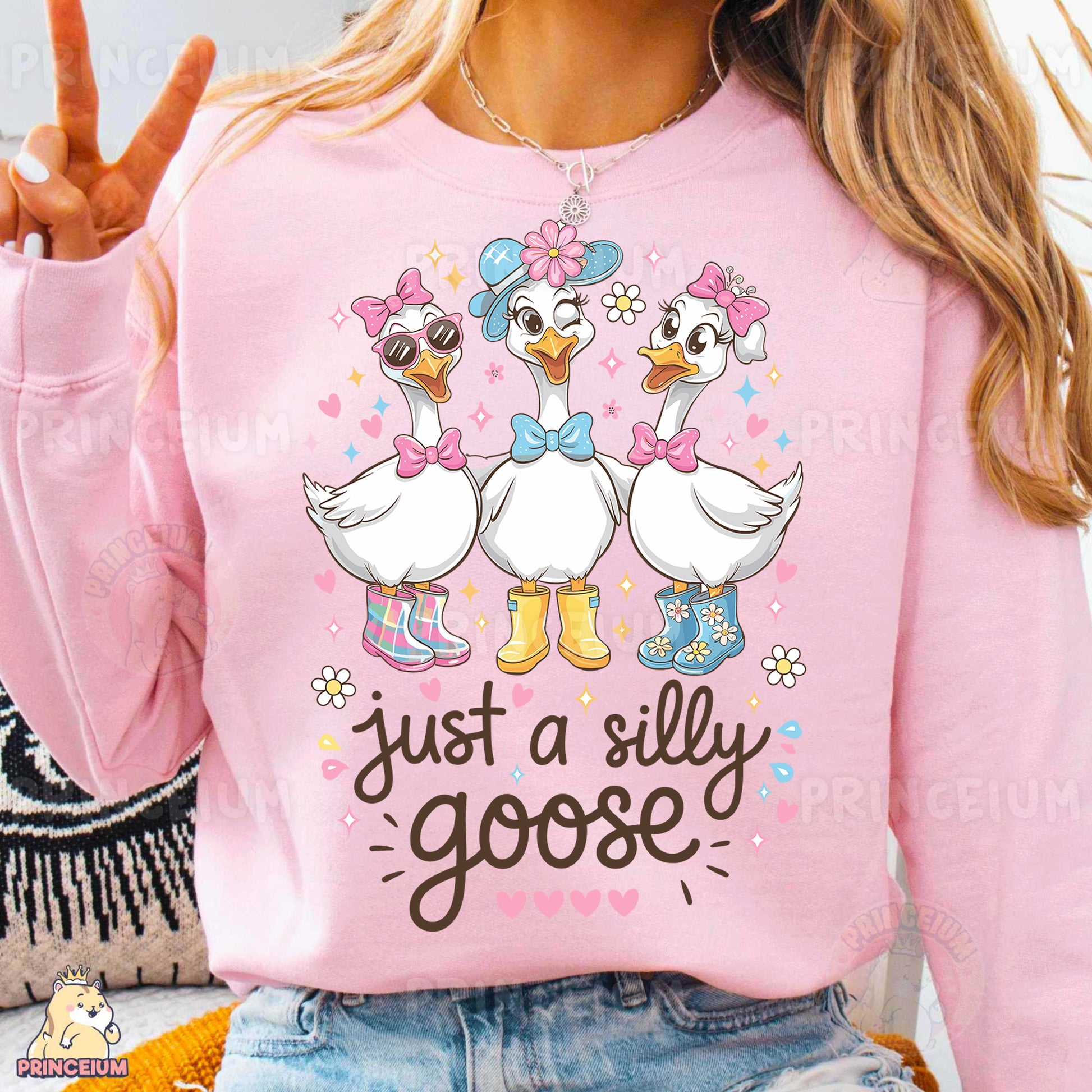 a woman wearing a pink shirt with two ducks on it
