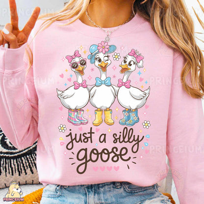 a woman wearing a pink shirt with two ducks on it