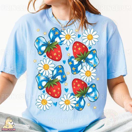 a woman wearing a blue t - shirt with a strawberry and daisies on it