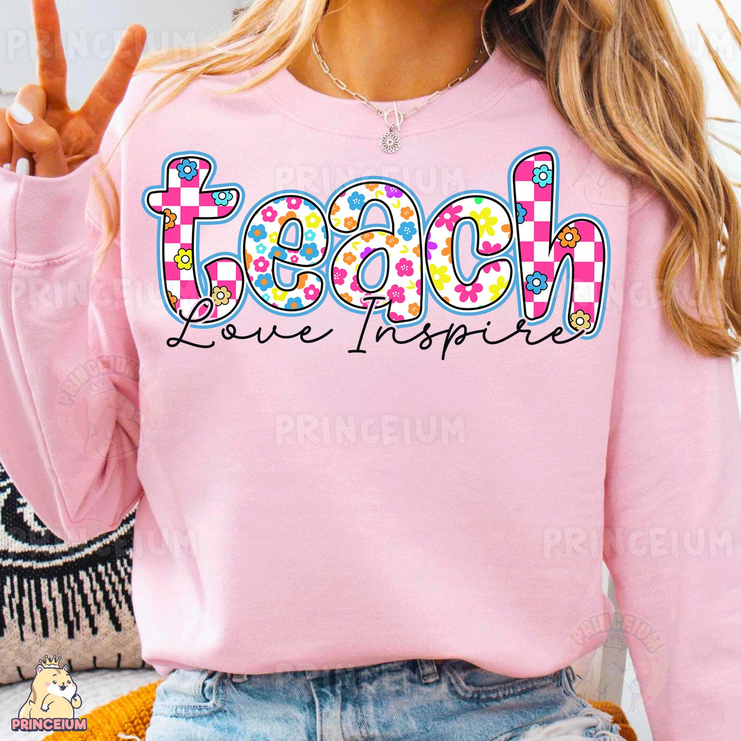a woman wearing a pink sweatshirt with the word teach on it