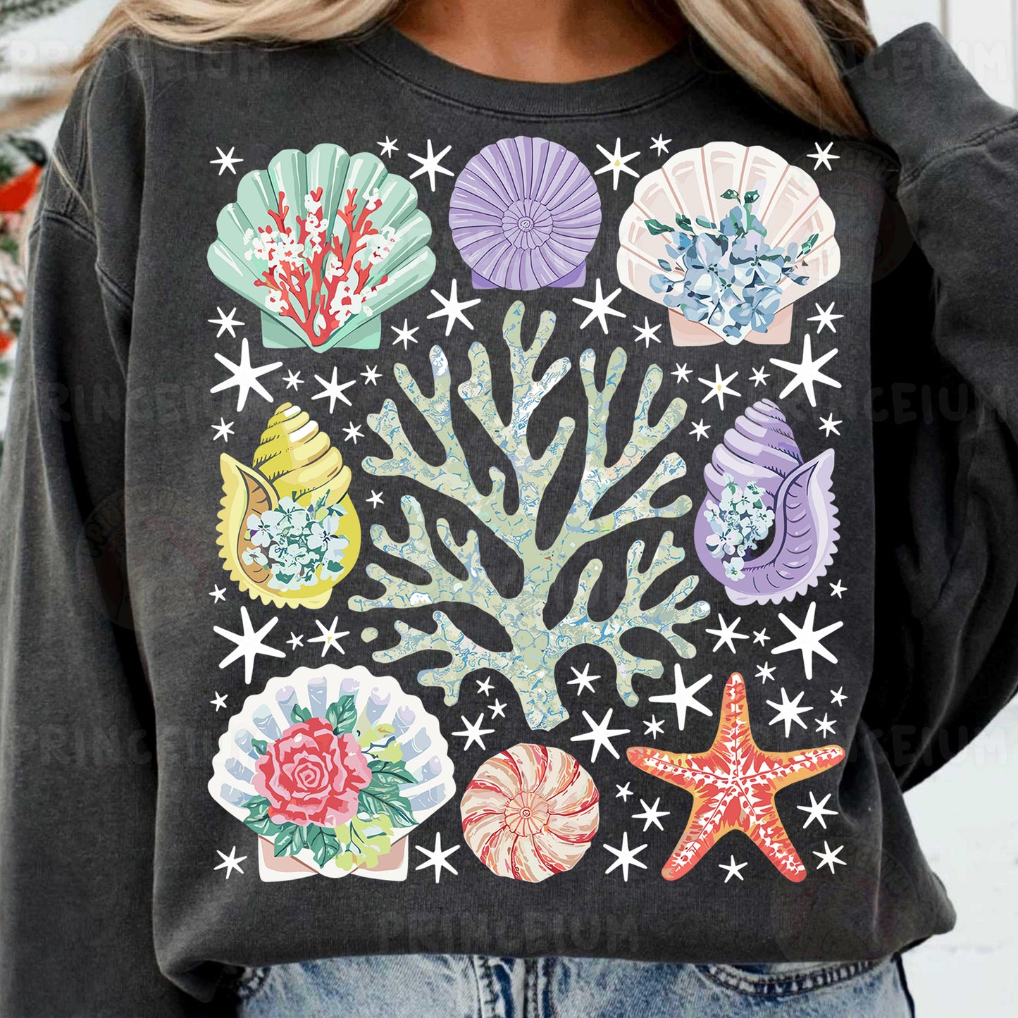a woman wearing a black sweatshirt with colorful seashells on it