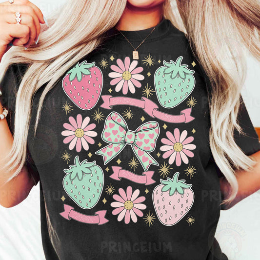 a woman wearing a black tshirt with pink flowers and strawberries on it
