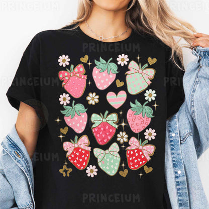 a woman wearing a black t - shirt with strawberries on it