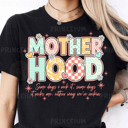 a woman wearing a t - shirt that says motherhood