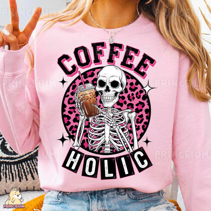 a woman wearing a pink sweater with a skeleton holding a cup of coffee