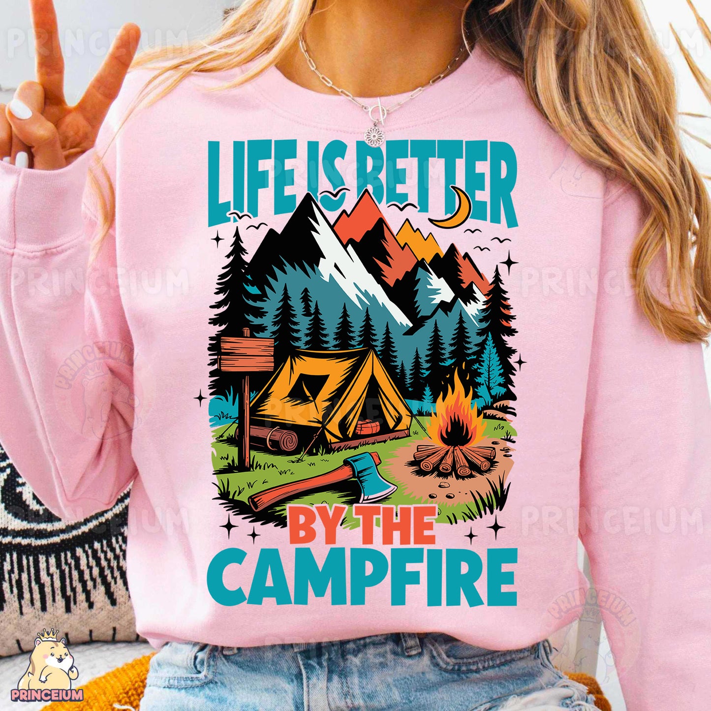 a woman wearing a pink shirt that says life is better by the campfire