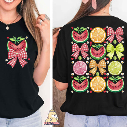 a woman wearing a black shirt with a bow and fruit design on it