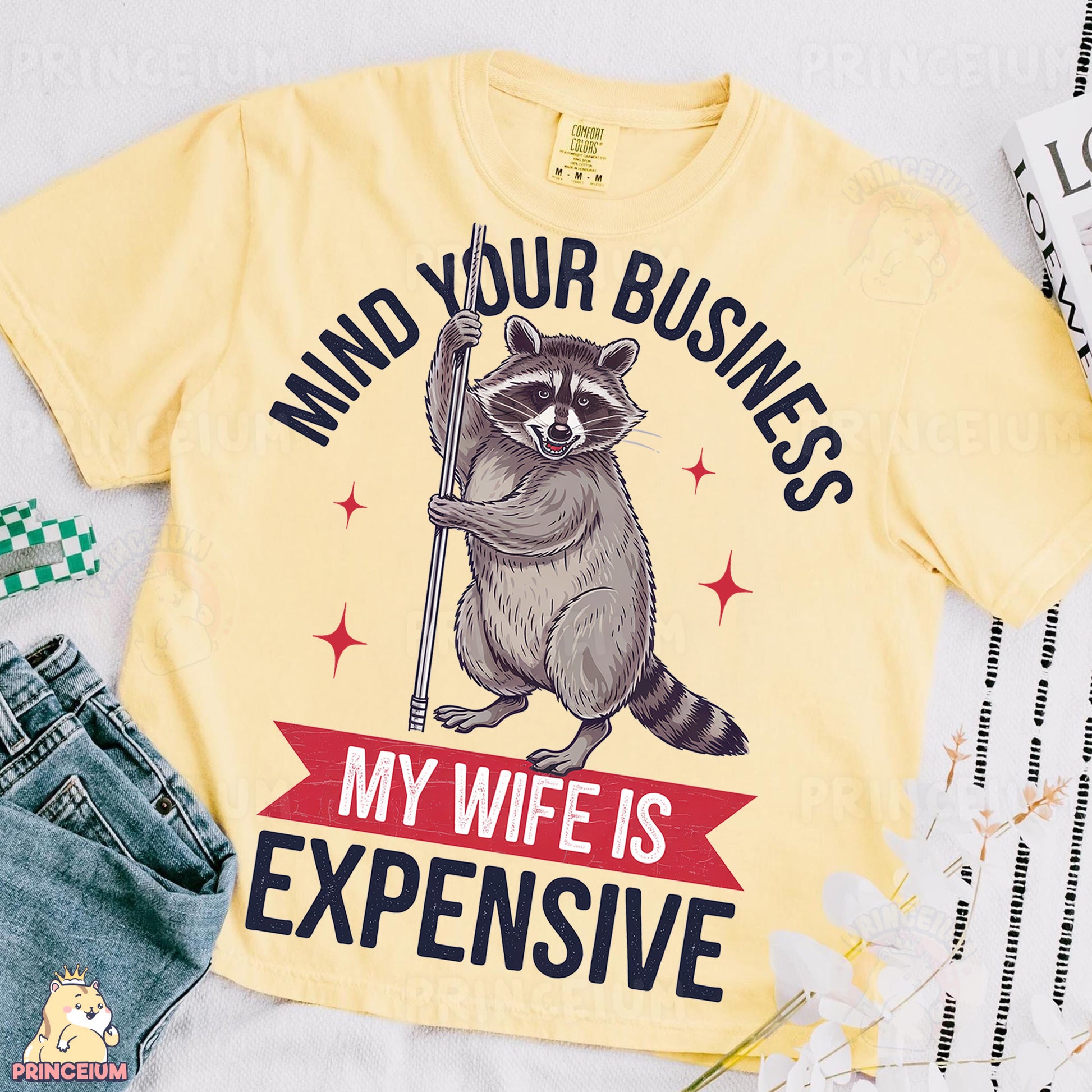 a yellow shirt with a raccoon on it